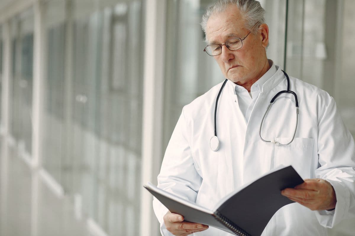 Senior healthcare advisor reviewing project documents in a modern facility
