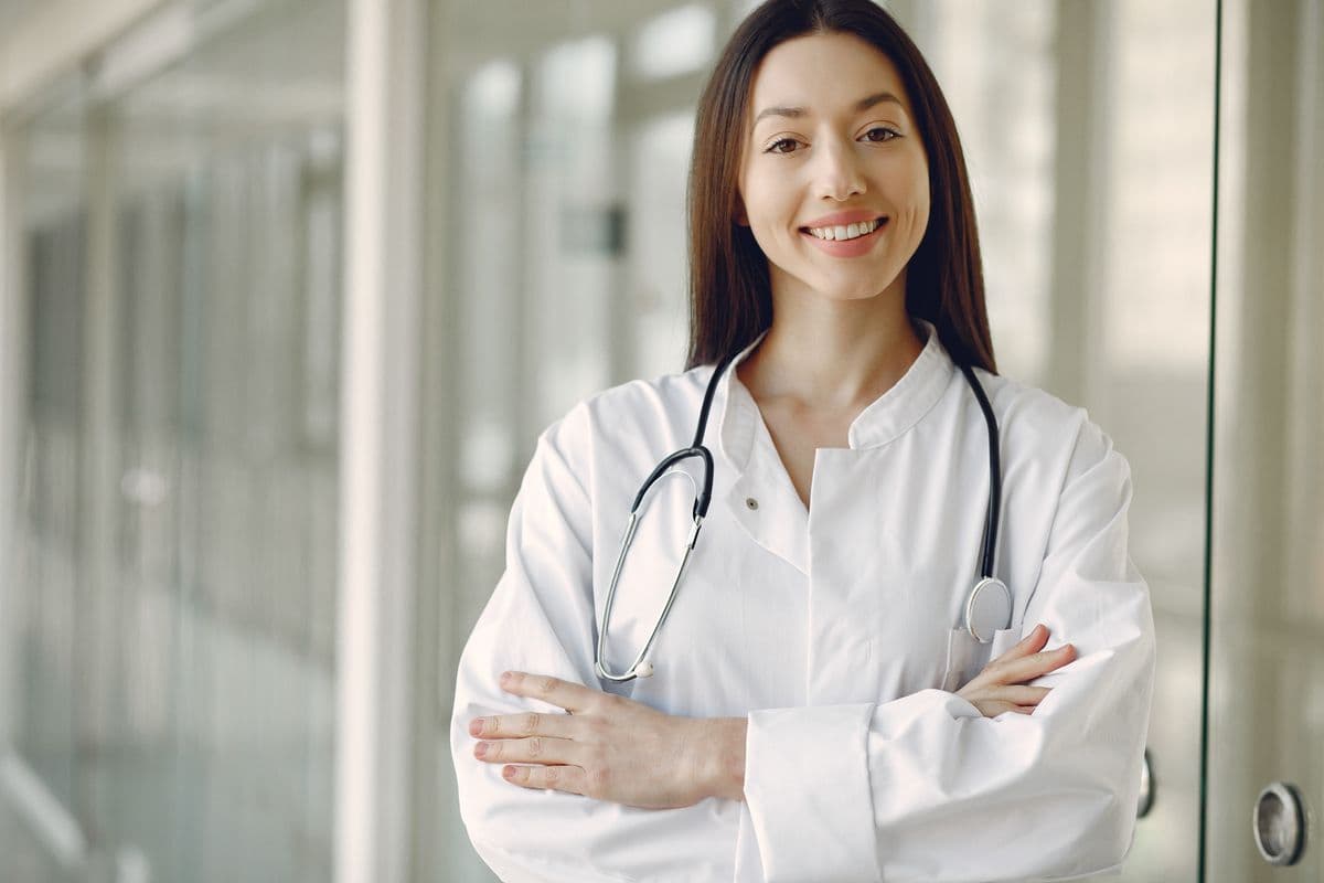Doctor standing in a bright modern clinic corridor