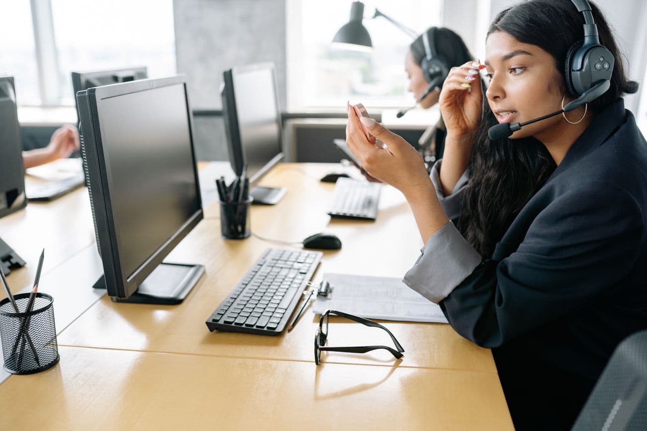 Support consultant on a headset at her desk