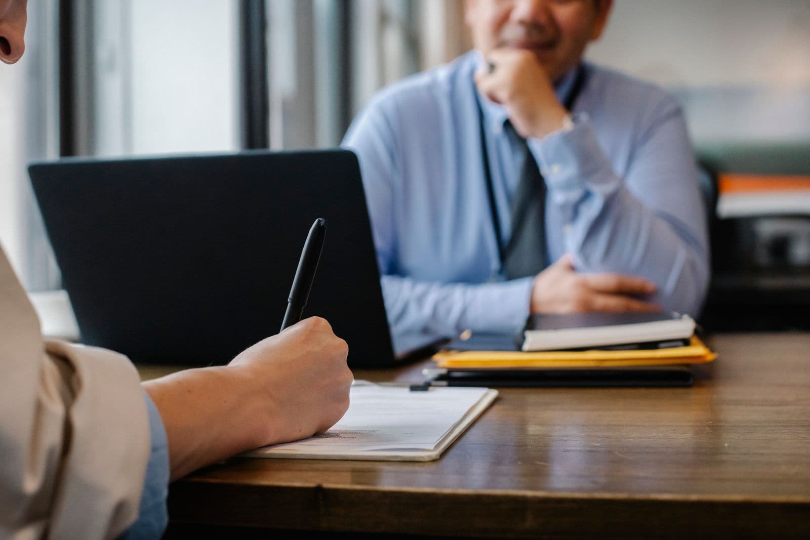 Healthcare consultant advising a client across a desk