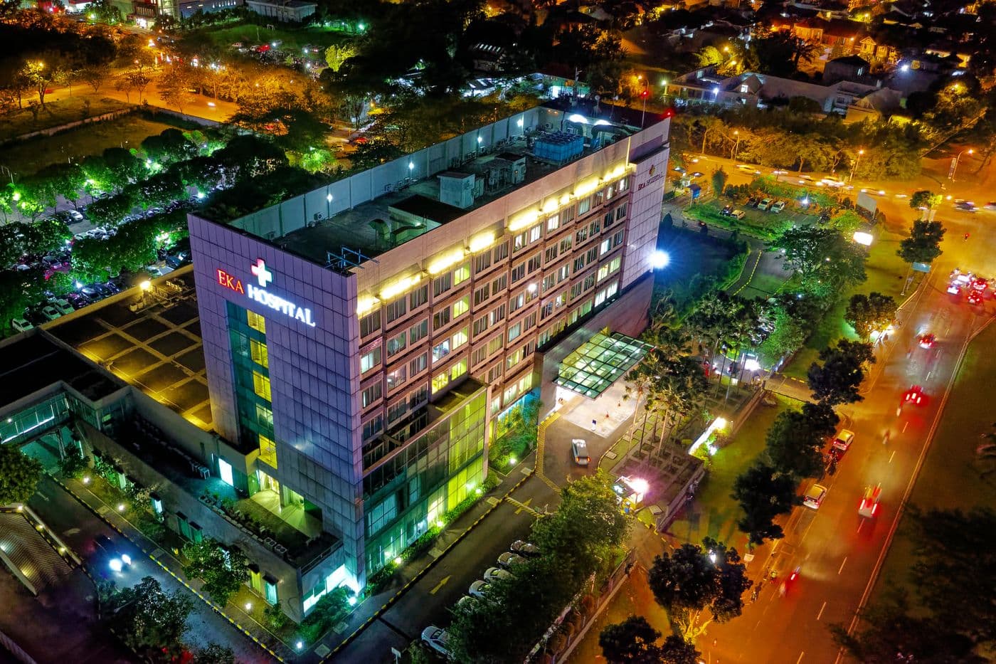 Modern multi-storey healthcare facility illuminated at night