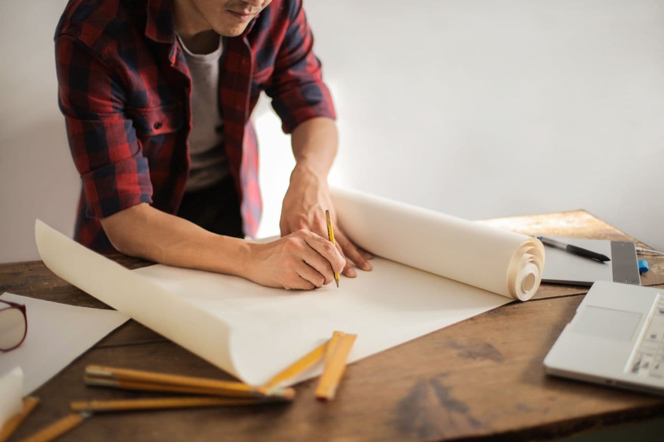 Drafting plans on a large paper roll