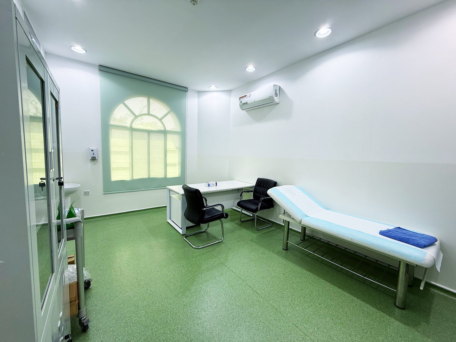 Consultation room with examination couch by the window in a poly clinic in Jumeirah, Dubai